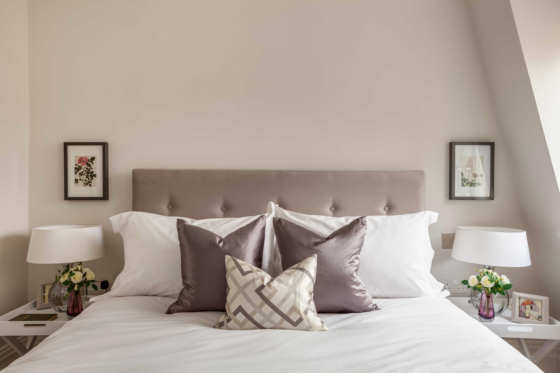 Neutral headboard in bedroom with lilac scatter cushions