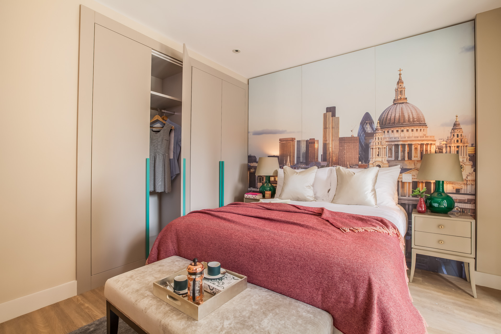 Bedroom with bespoke joinery, with modern interior scheme of reds, greens and beige