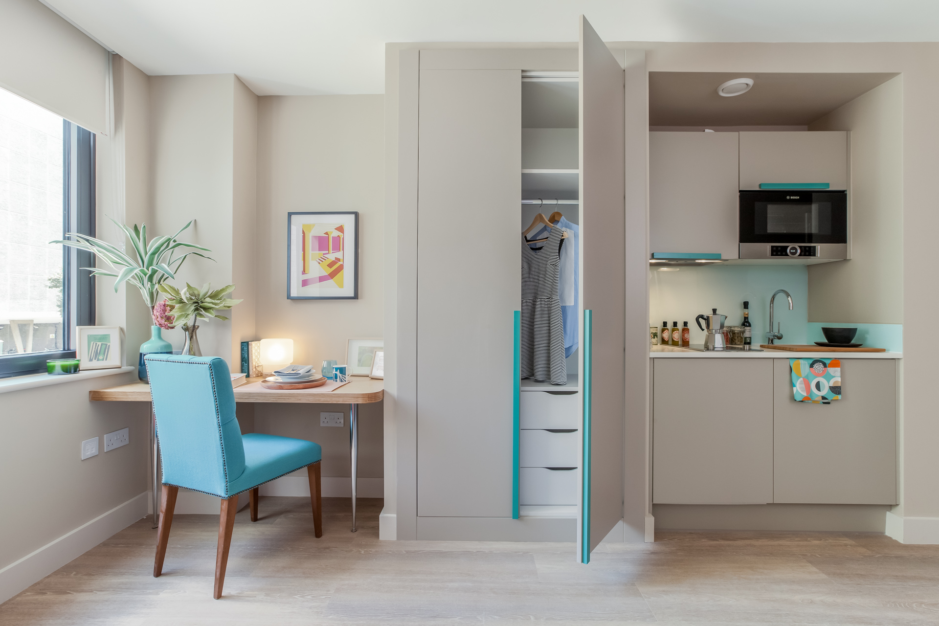 built in study area Desk, wardrobe and kitchen area. Contemporary blue handles and grey wardrobe