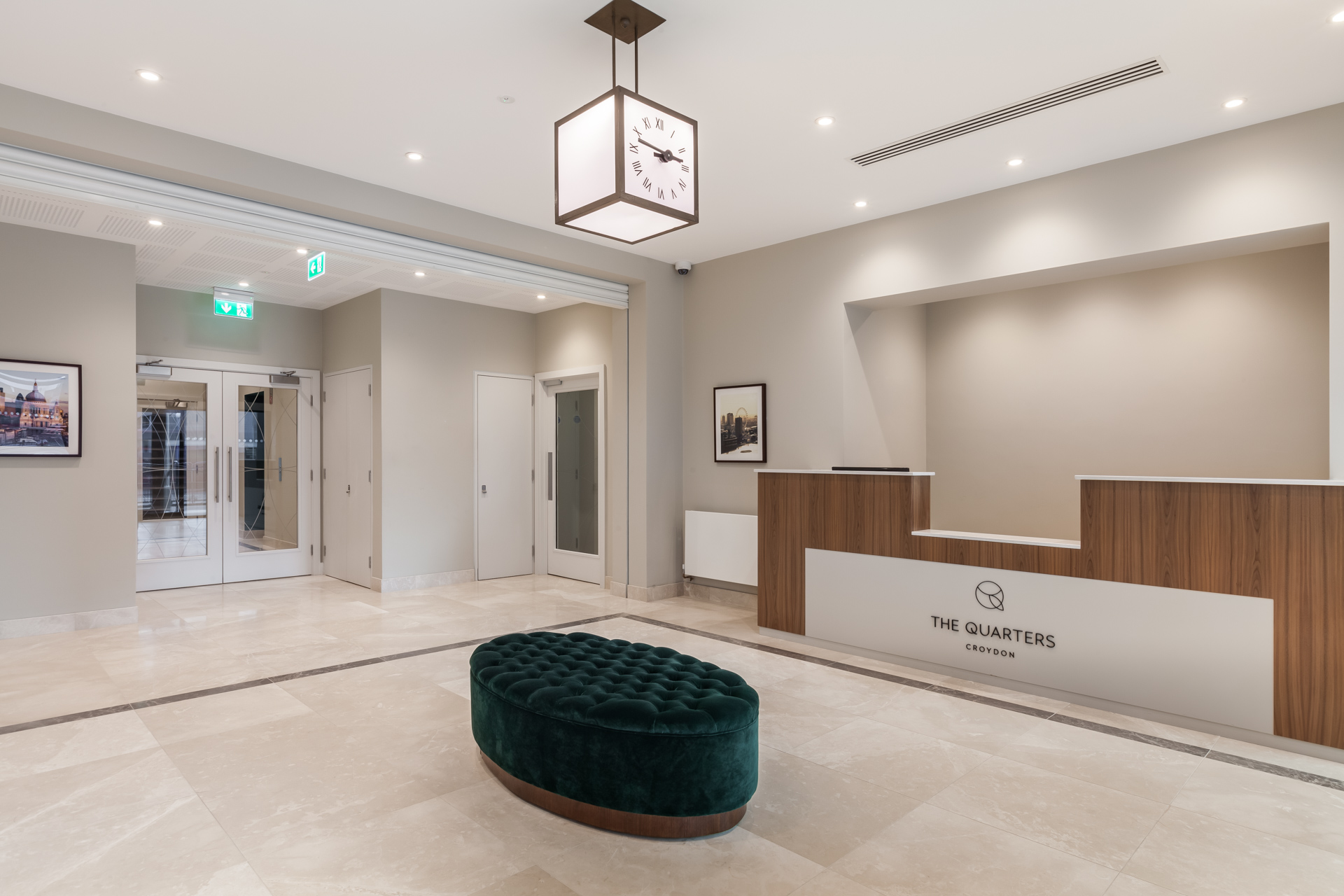lobby and reception area with Quirky clock light limestone floor tiles, green ottoman