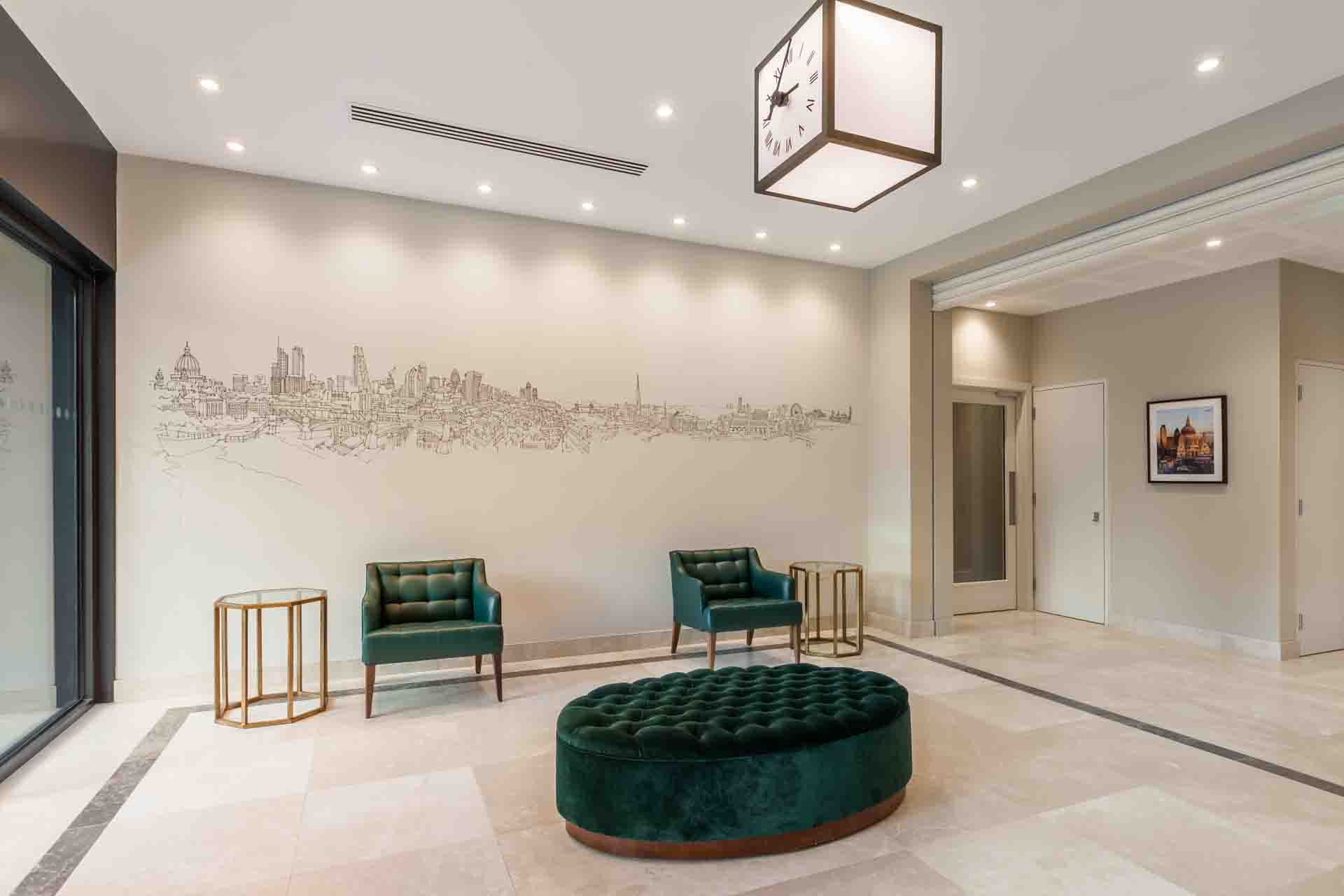 environmental graphic of London skyline illustration wall mural, light, hexagonal side tables and green furniture