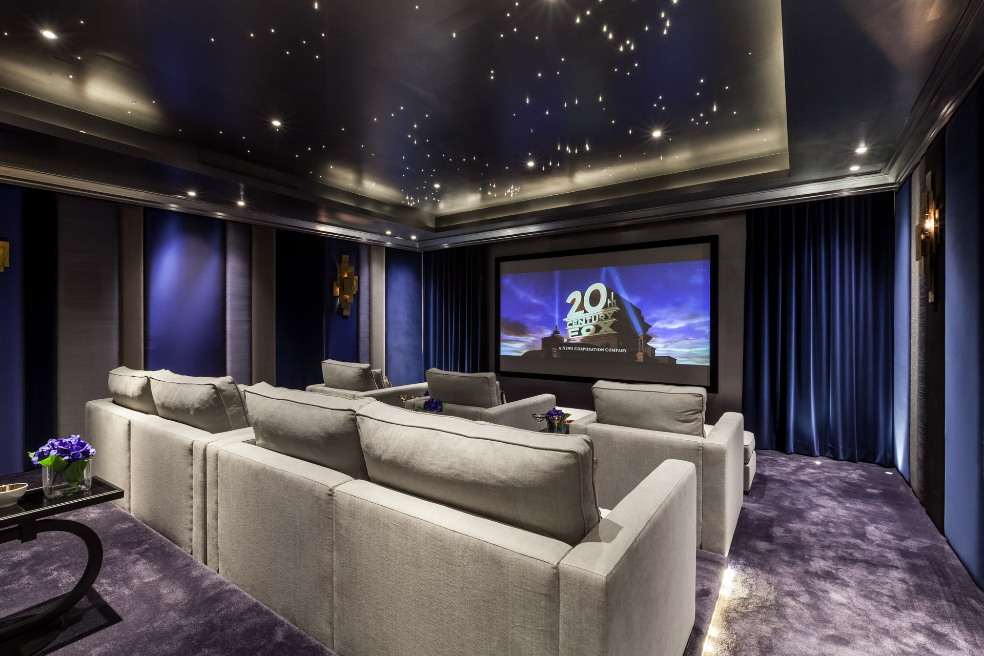 private cinema room in purple and grey with recessed ceiling